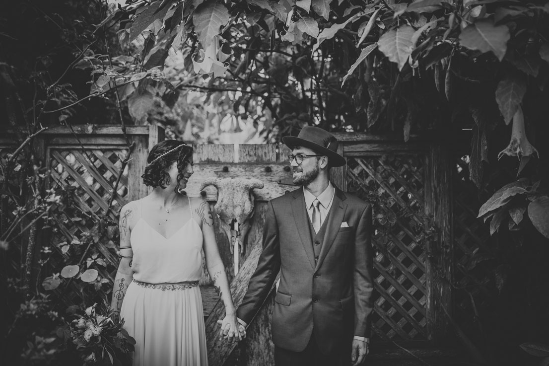 Portrait of wedding couple holding hands in a beautiful garden by Becca Henry Photography