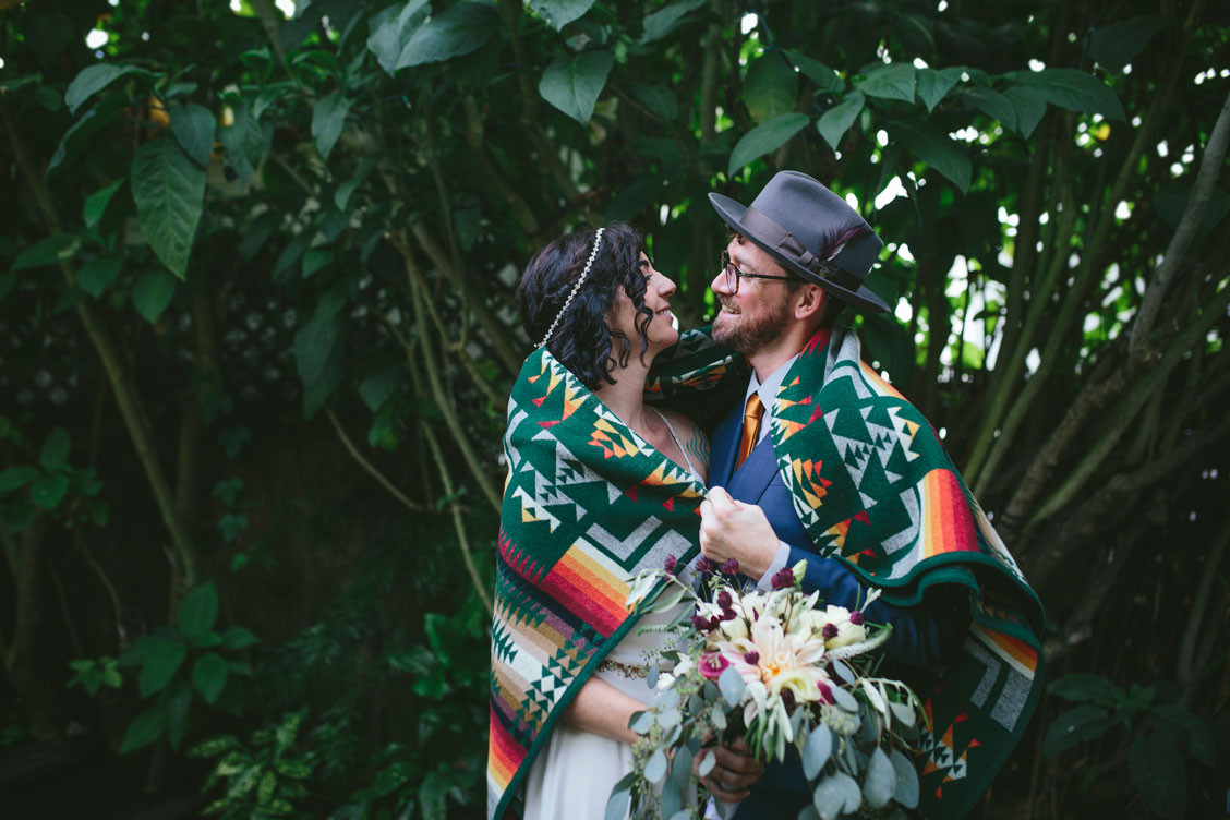 Snuggles under a Pendleton blanket at Stinson Beach wedding by Becca Henry Photography