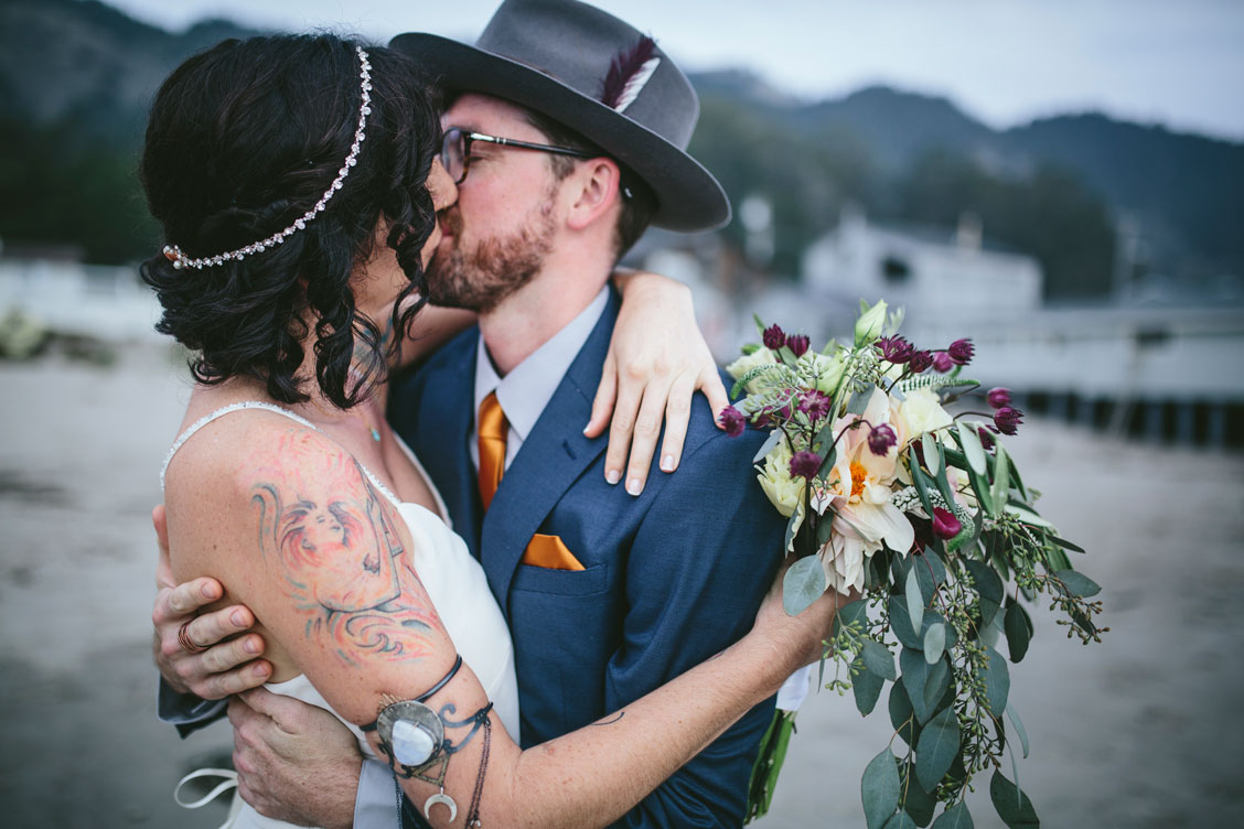 Passionate kiss at Stinson Beach wedding by Becca Henry Photography
