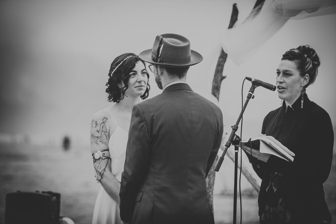 BW image of couple reciting vows on beach at Stinson Beach Wedding by Becca Henry Photography