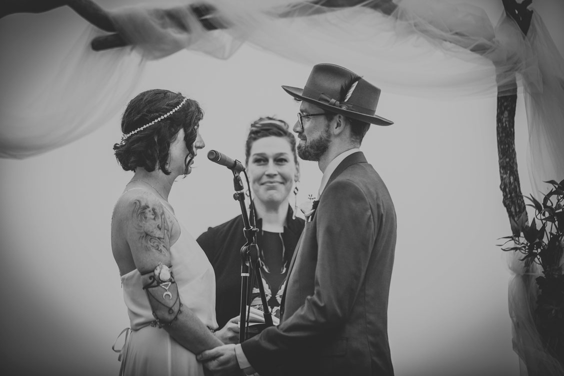 BW image of couple reciting vows on beach at Stinson Beach Wedding by Becca Henry Photography
