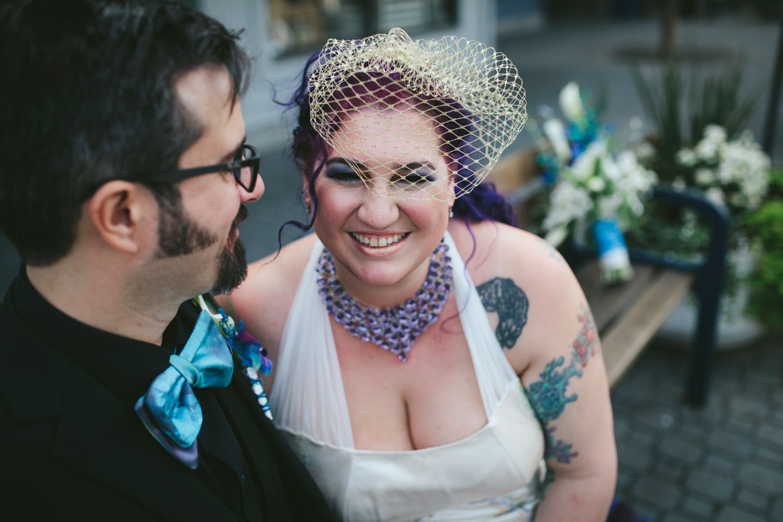 Laughing, tatted bride snuggling up to groom in Jack London by Becca Henry Photography