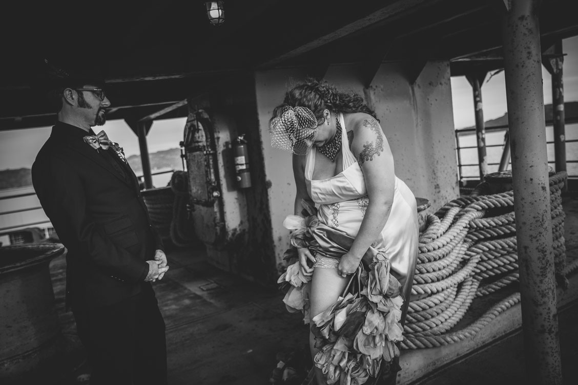 Bride fixing garter before the ceremony by Becca Henry Photography