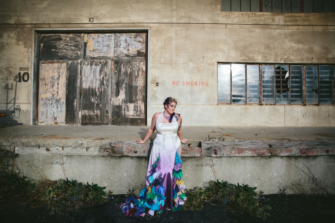 Portrait of bride with purple hair and peacock inspired dress by Becca Henry Photography