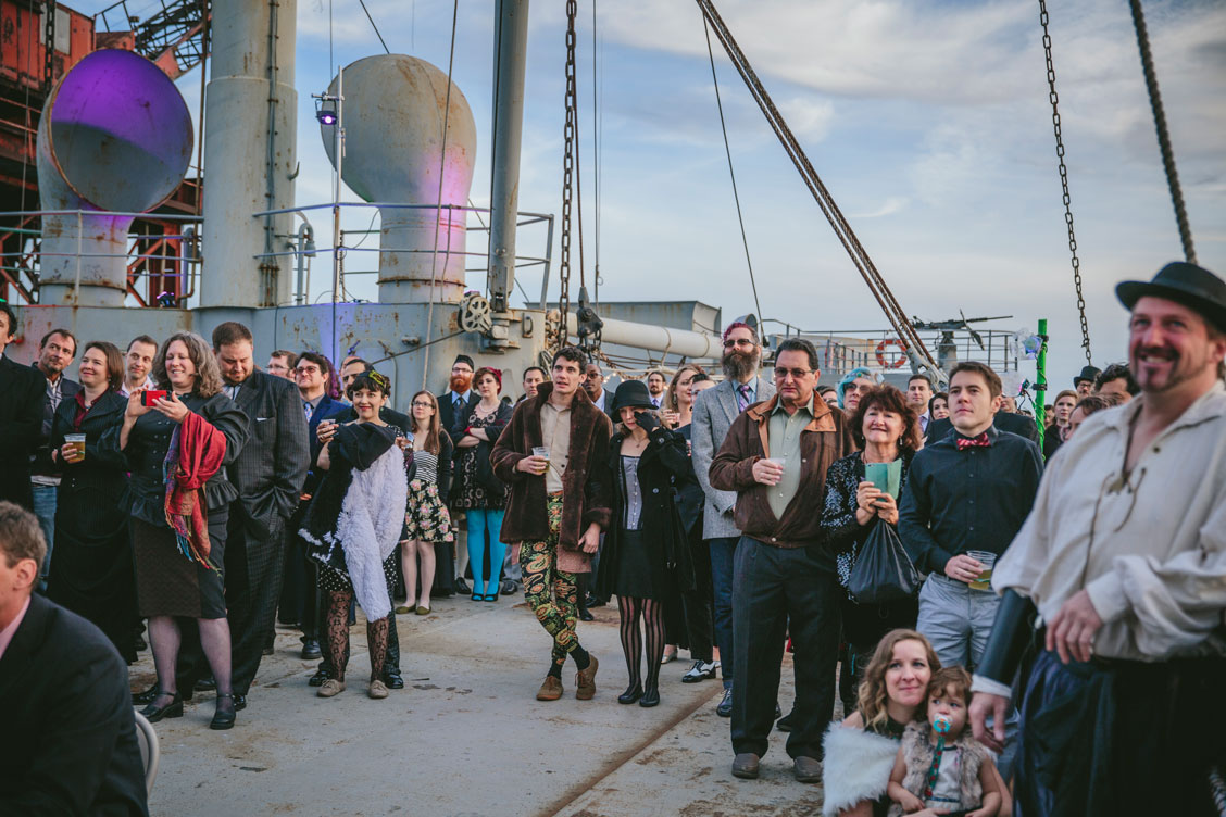 Wedding guests watching the ceremony on SS Red Oak Victory by Becca Henry Photography
