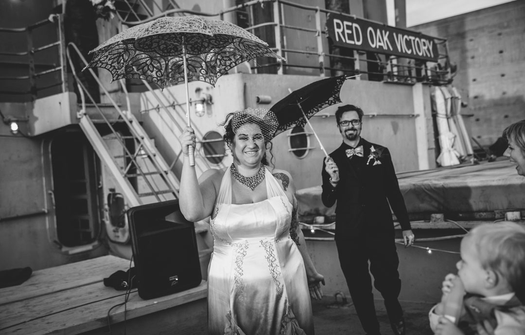 Just wed couple doing the traditional New Orleans style wedding recession dance aboard the SS Red Oak Victory by Becca Henry Photography.
