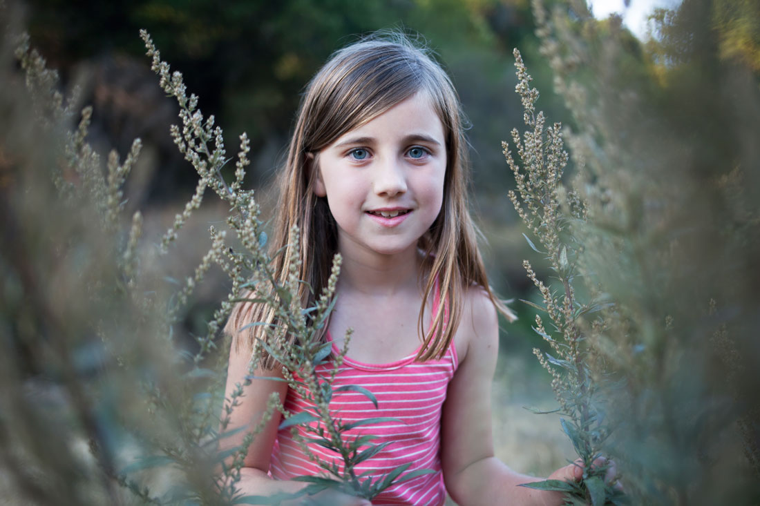 Girl surrounded by tall grass- Family photography by Becca Henry Photography