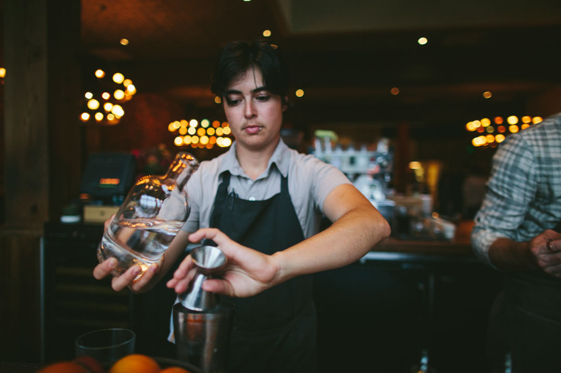 Bartender making drinks for cocktail hour for wedding reception at Oakland venue, El Camino by Becca Henry Photography