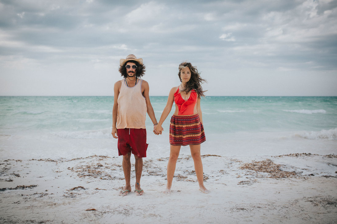 In love and holding hands on Mexican beach by Becca Henry Photography