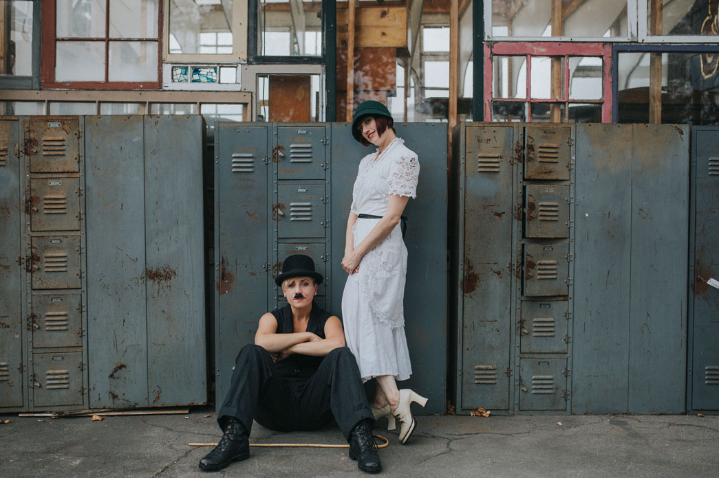 Editorial engagement photography Charlie Chaplin and ingenue by old school lockers at Ohmega Salvage by Becca Henry Photography