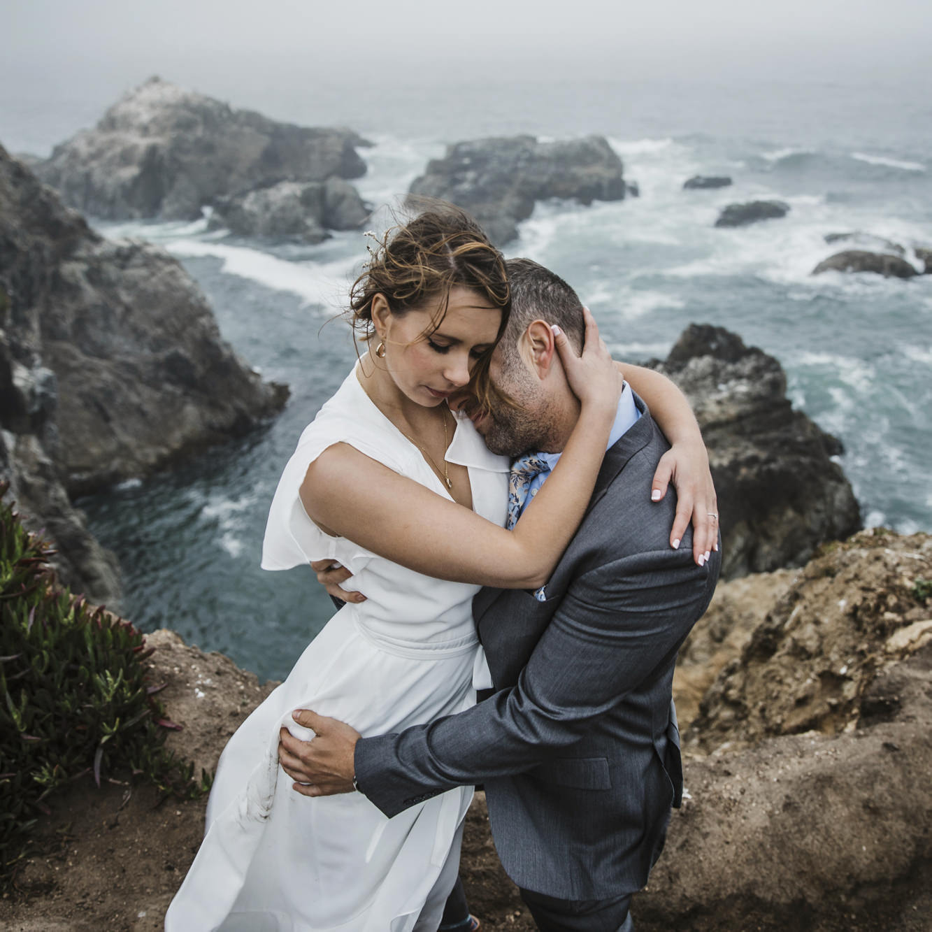 Bodega Bay Engagement Session tender moment- couple embrace at cliff's side