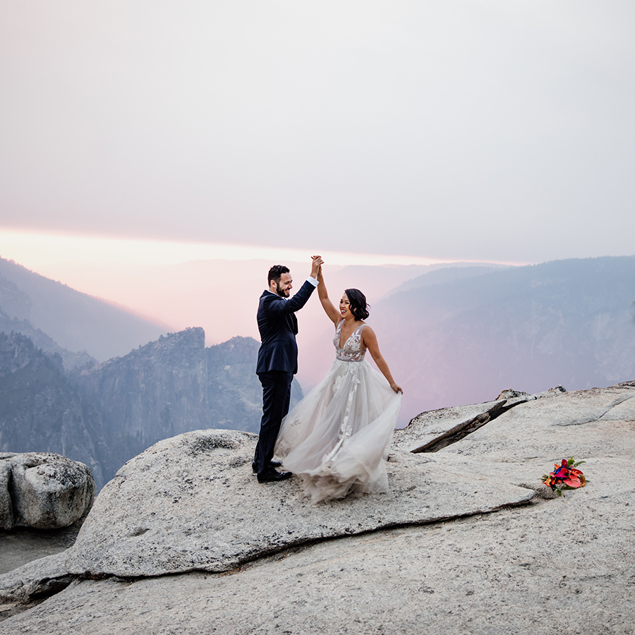 Bride and groom twirl at Taft Point for Yosemite Elopement