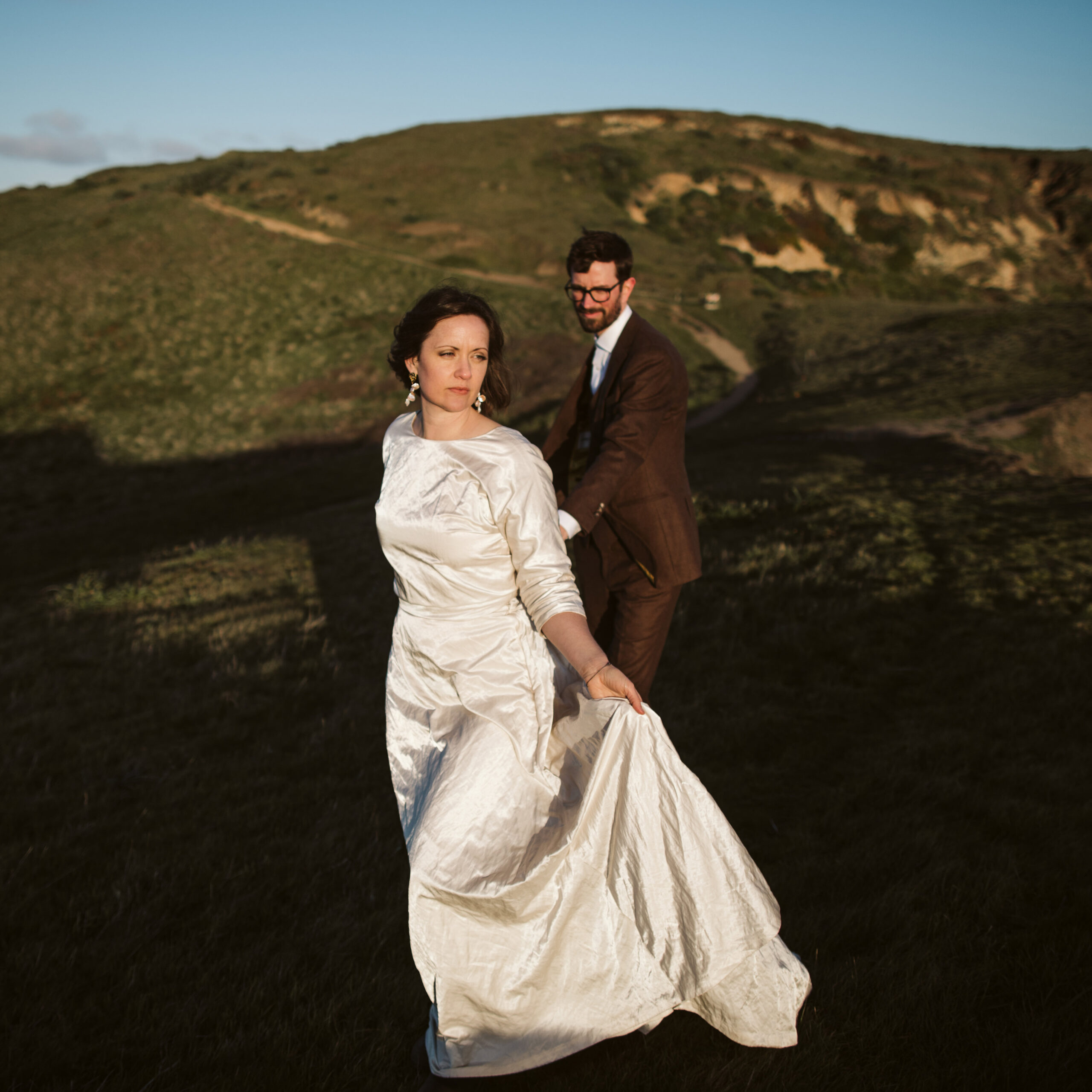 Bride and groom walking along beautiful cliff side for Point Reyes Elopement