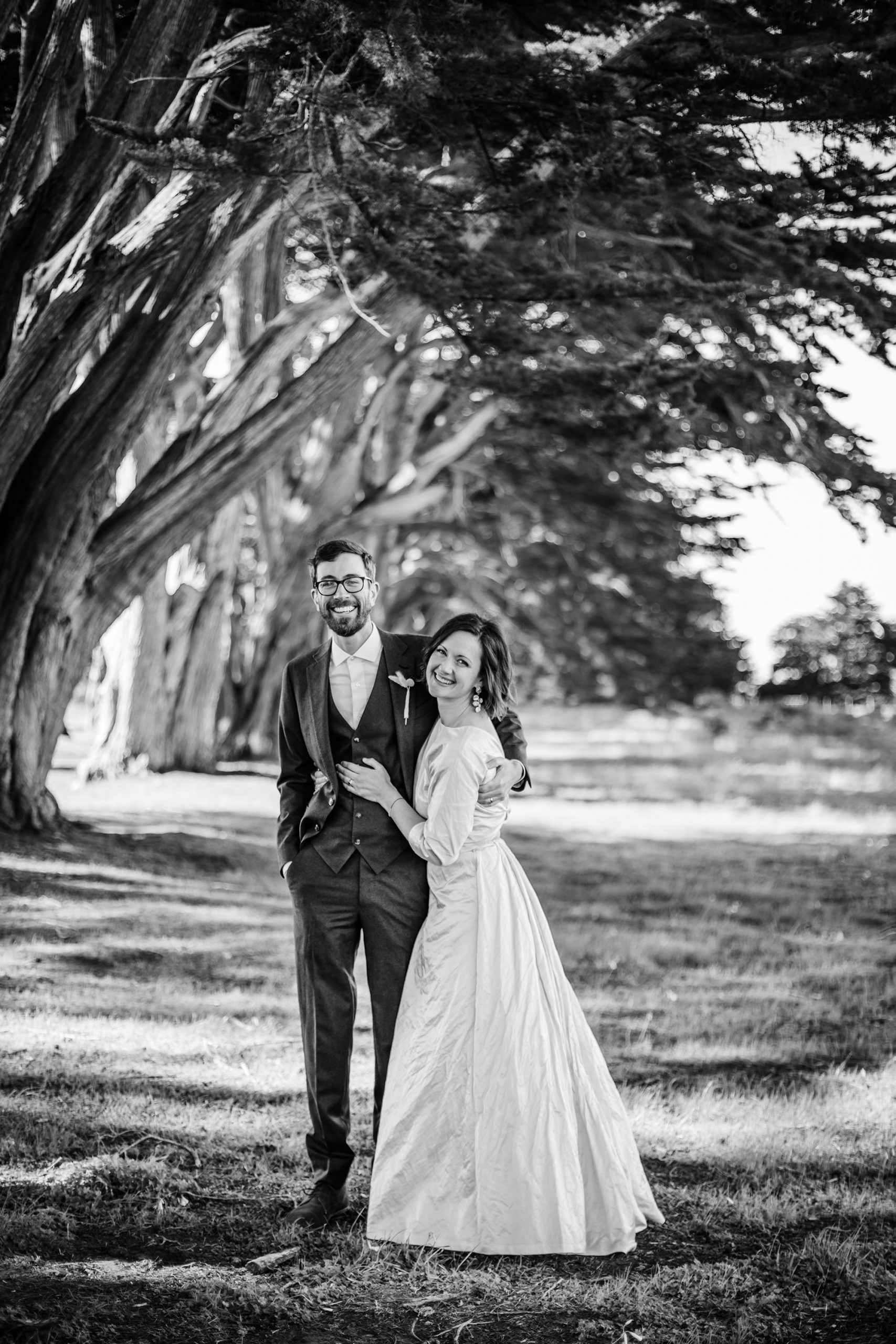 Groom and Bride having fun the Cypress Tree Tunnel for Point Reyes Elopement.