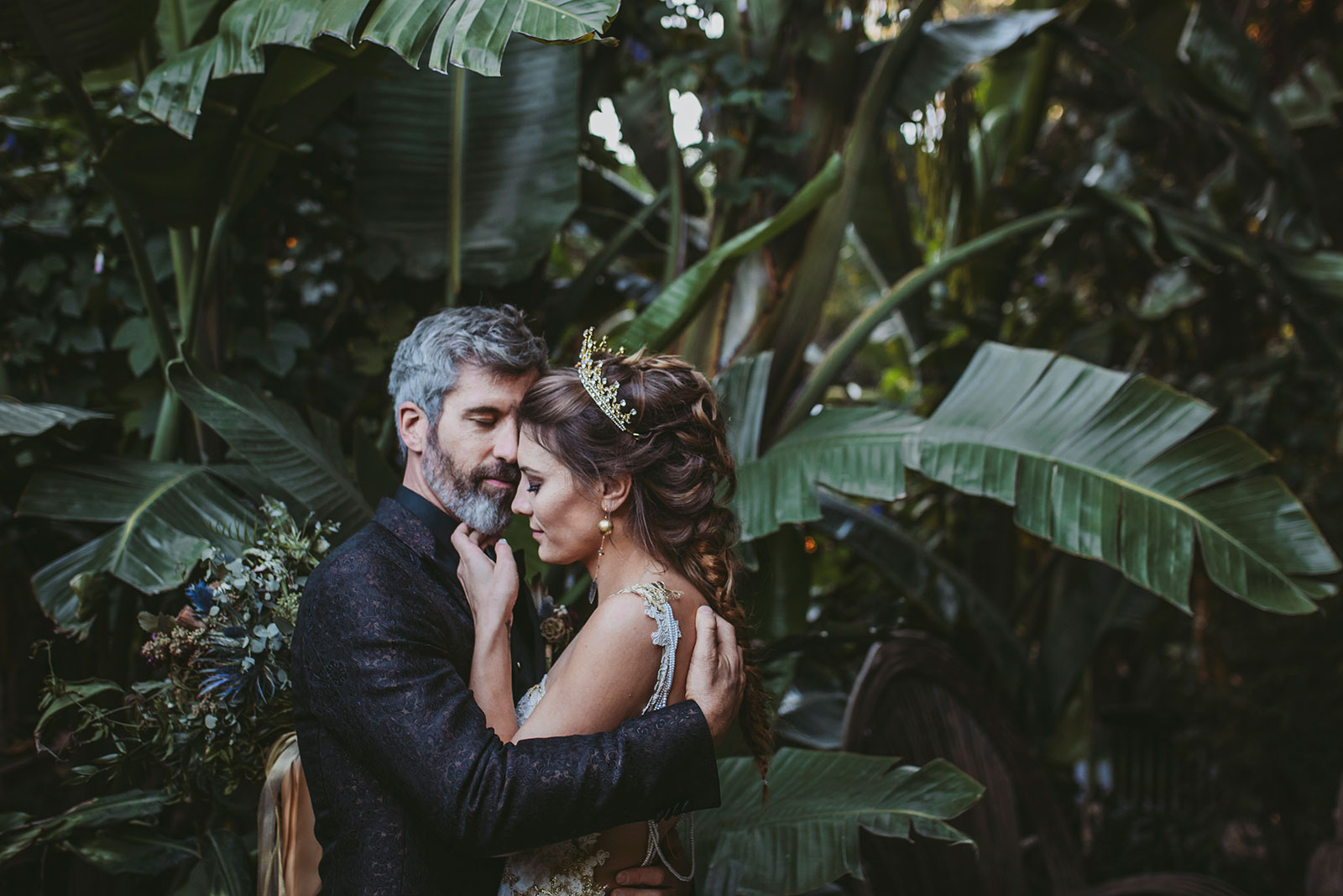 Bride and groom share a sweet moment in the lush gardens of The Holly Farm at this Carmel Wedding.