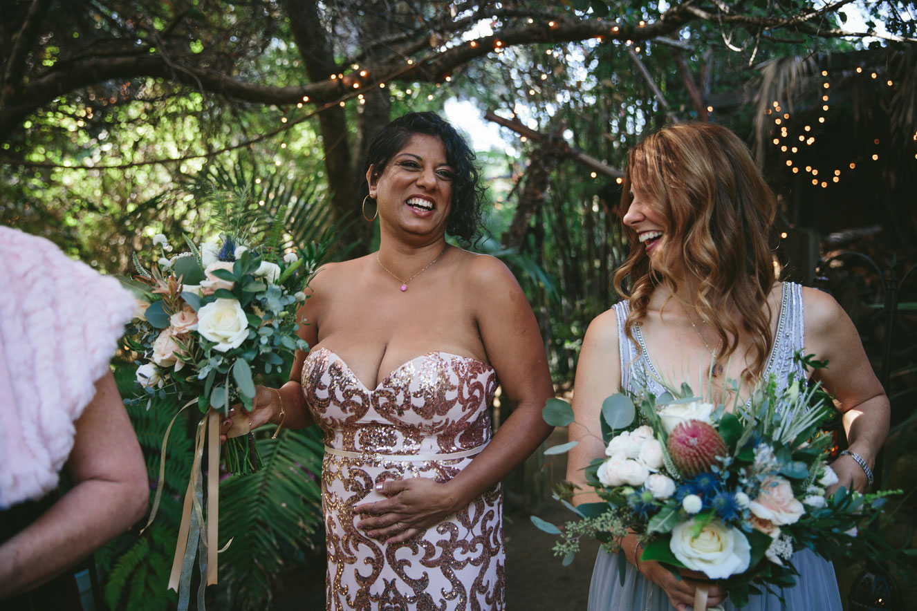 The wedding party getting ready and laughing before the ceremony