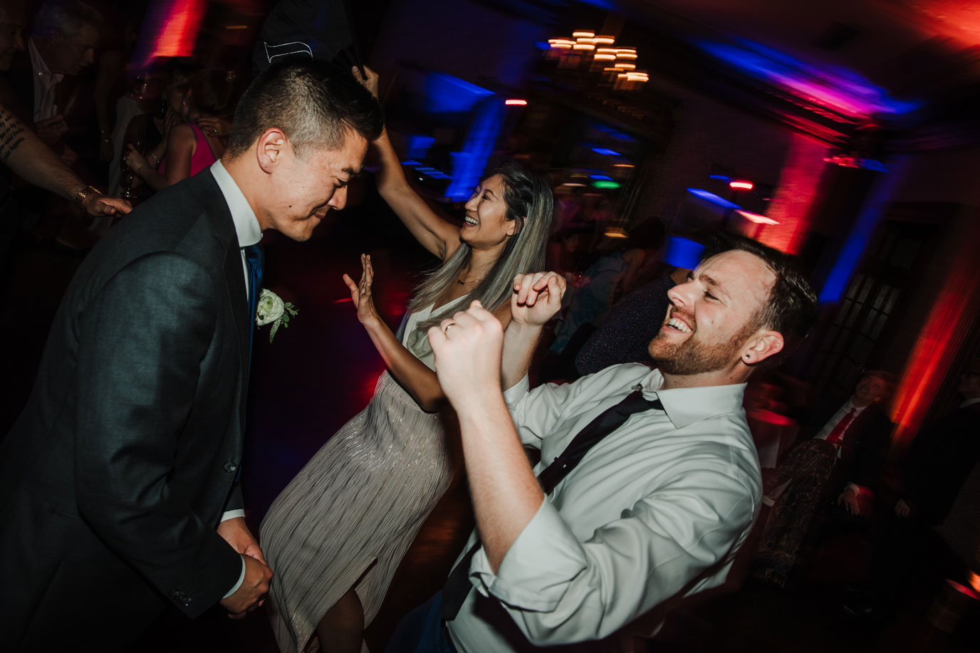 Grooms dancing at their super fun reception - The University Club of San Francisco