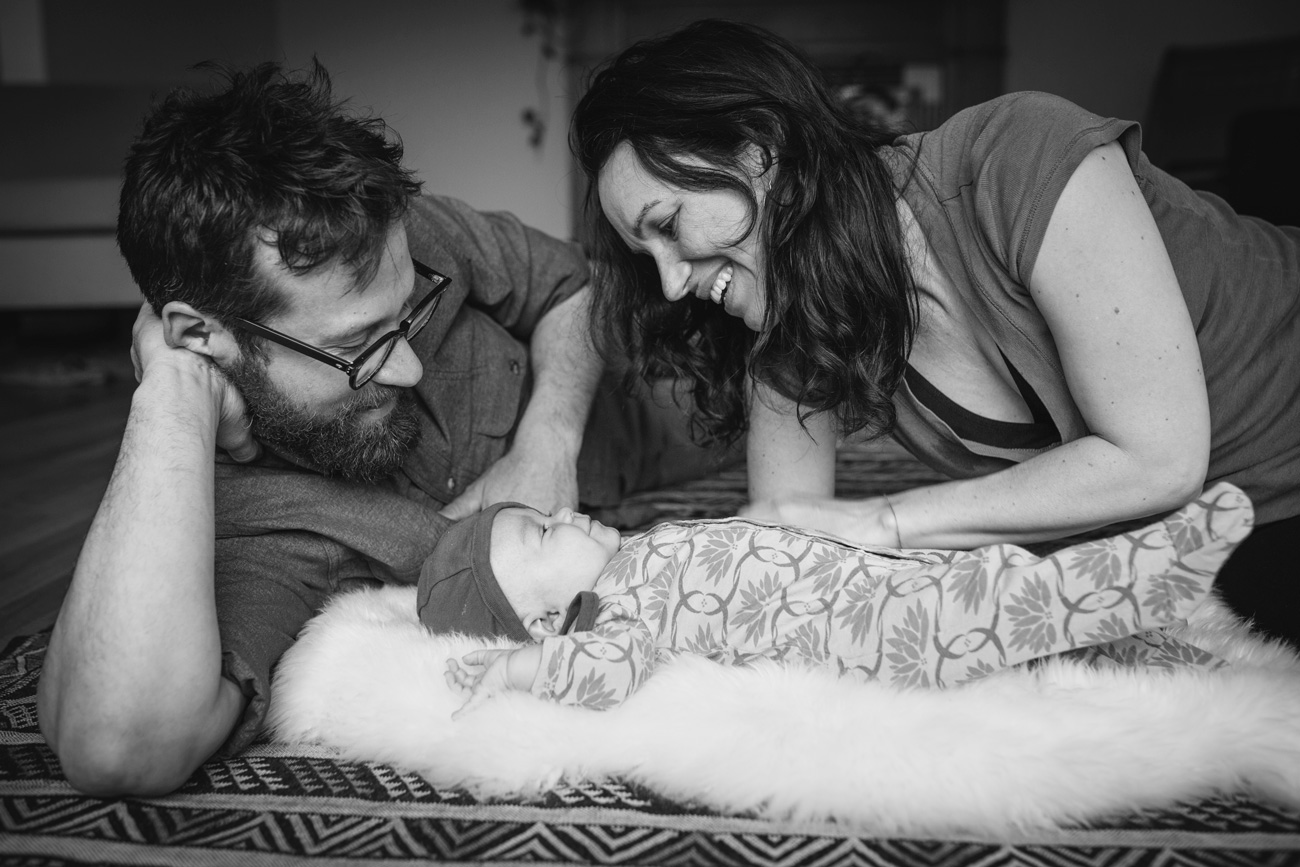 Becca Henry Photography - Oakland Newborn Photography - BW image of parents looking over baby