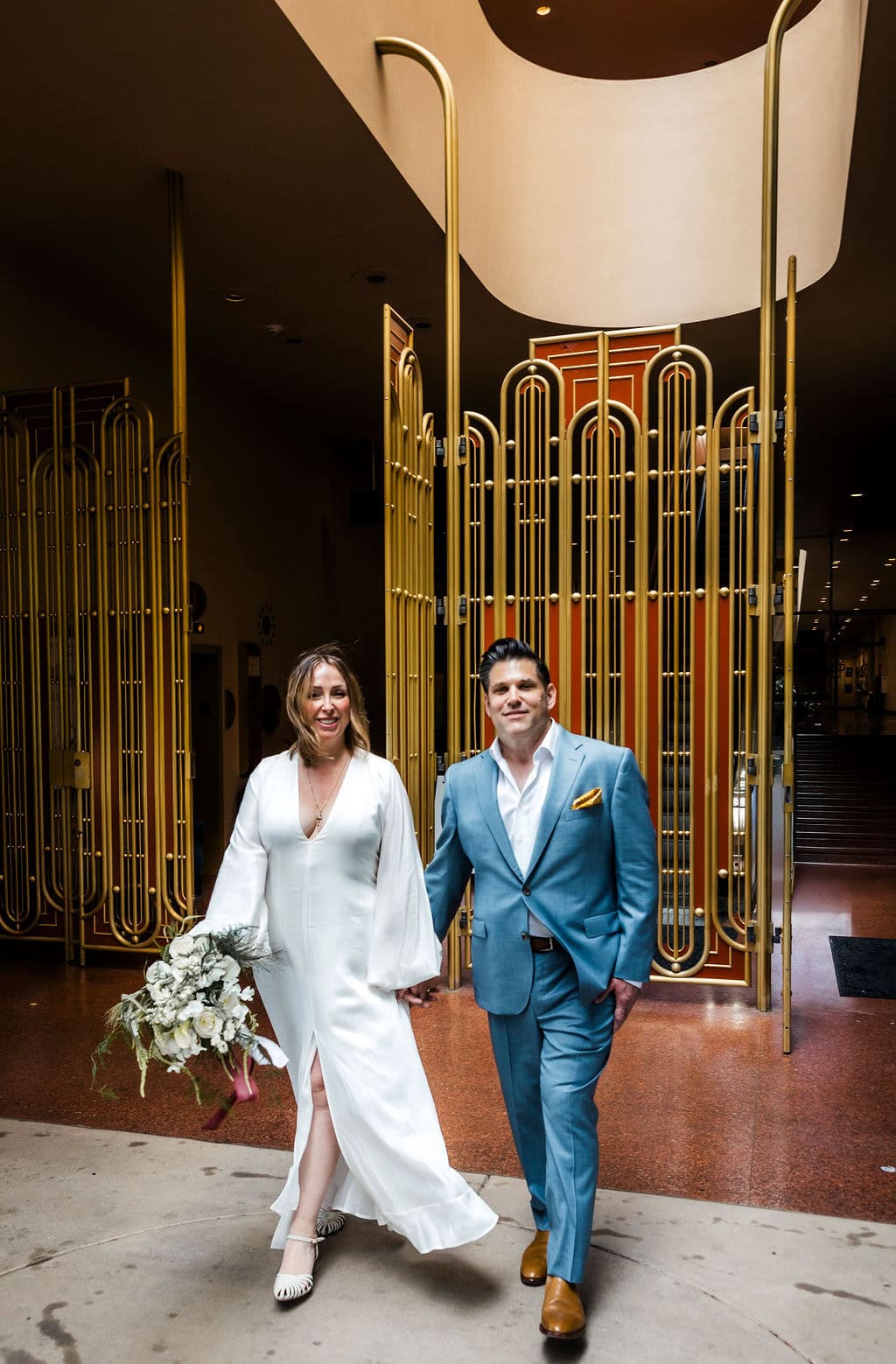Elegant couple at a modern venue for a wedding or event.
