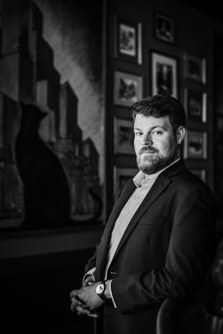 Professional portrait of a man in a suit at the new BH branding website launch.